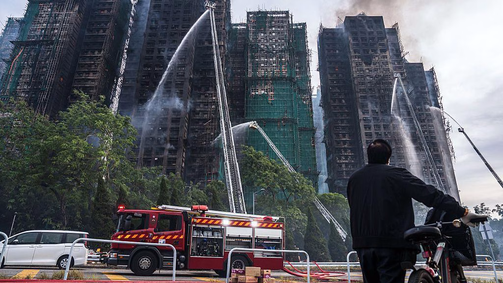 At least 55 dead and hundreds missing in Hong Kong as firefighters battle last of public housing fires